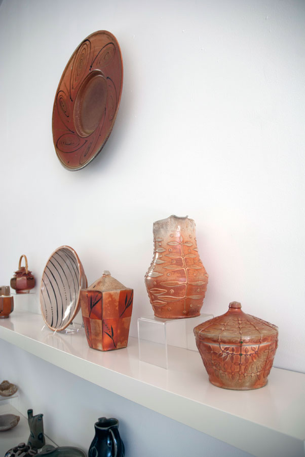 Andy Balmer & George Rector Andy Balmer, Platter, 2013. Soda/salt-fired stoneware (hanging on wall). George Rector, Covered Jars, Pitcher and Bowl, 2013. Stoneware, wood-fired, salt & soda glazed, Madison Metro photograph