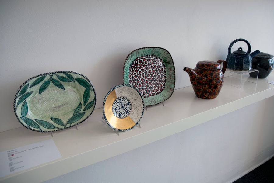 Gail Kendall, Half-Gold Dish, 2012. Slipped terracotta with 22 karat burnished gold luster; Leaves, 2013, Slipped terracotta; Dots, 2013, Slipped terracotta; Teapot, 2014. Slipped terracotta, Madison Metro photograph