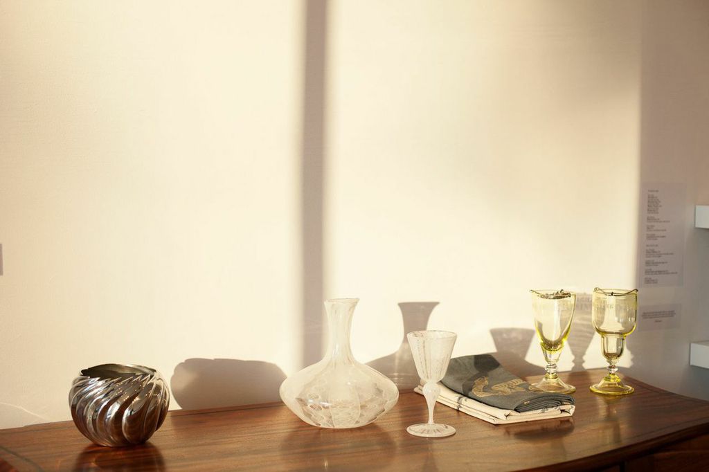 (L to R): Victor DiNovi, Liquor Cabinet, African mahogany; Randy Stromsoe, Ice Bowl, pewter, chased and carved; Aya Oki, Pale Lace Pattern Decanter and Goblet, blown glass; Rya Kihlstedt, Snake and Botanical Bar Towels, hand-silkscreened table linens; Orbix Hot Glass, Jade Handblown Uranium Reservoir Absinthe Glass and Jade Handblown Uranium Chopes Absinthe Glass, blown glass