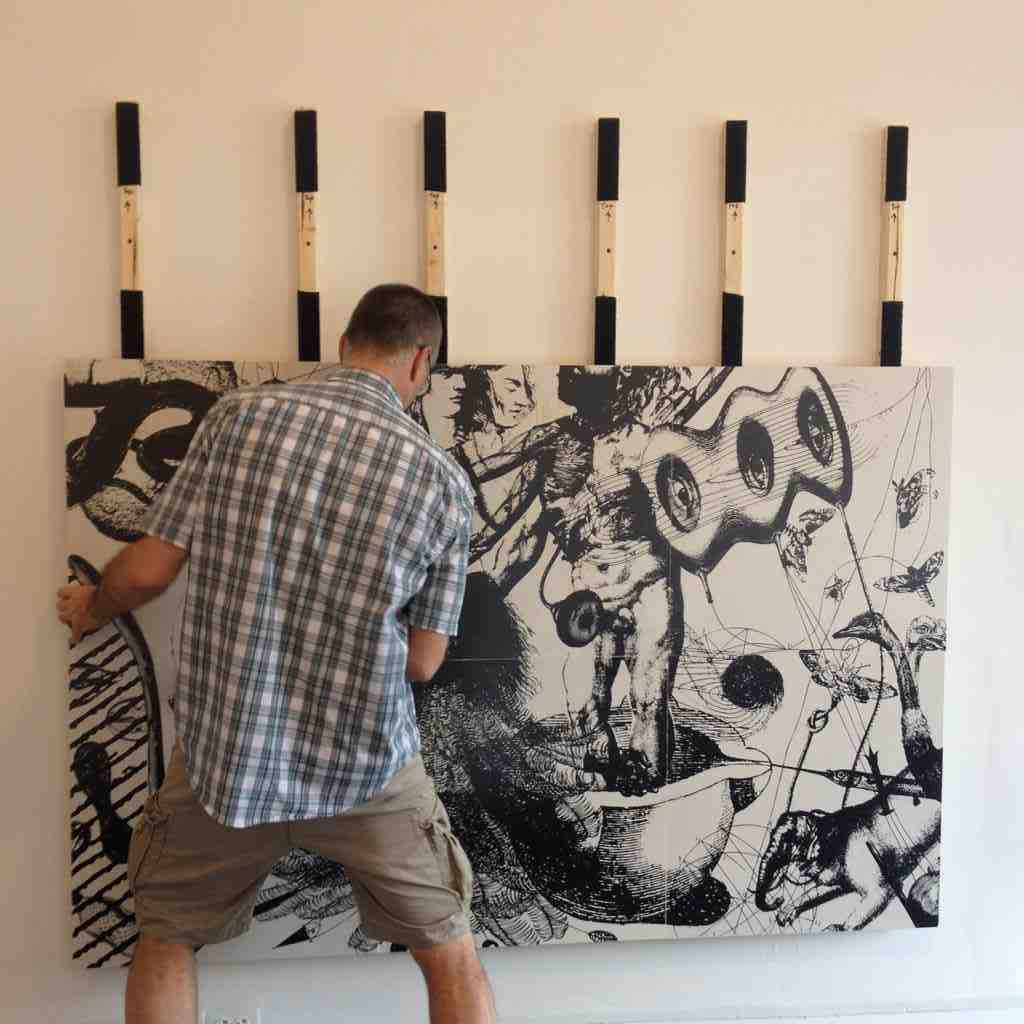 Vince Palacios installing his porcelain tile piece, Dark Persuasions