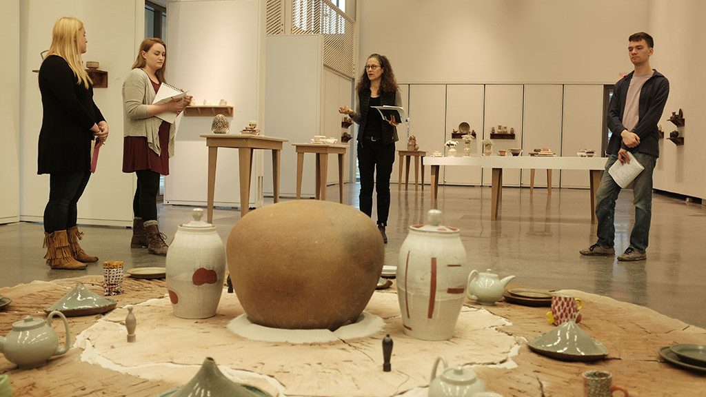 Linda Sikora, Professor of Ceramic Arts at Alfred University, works with her senior students