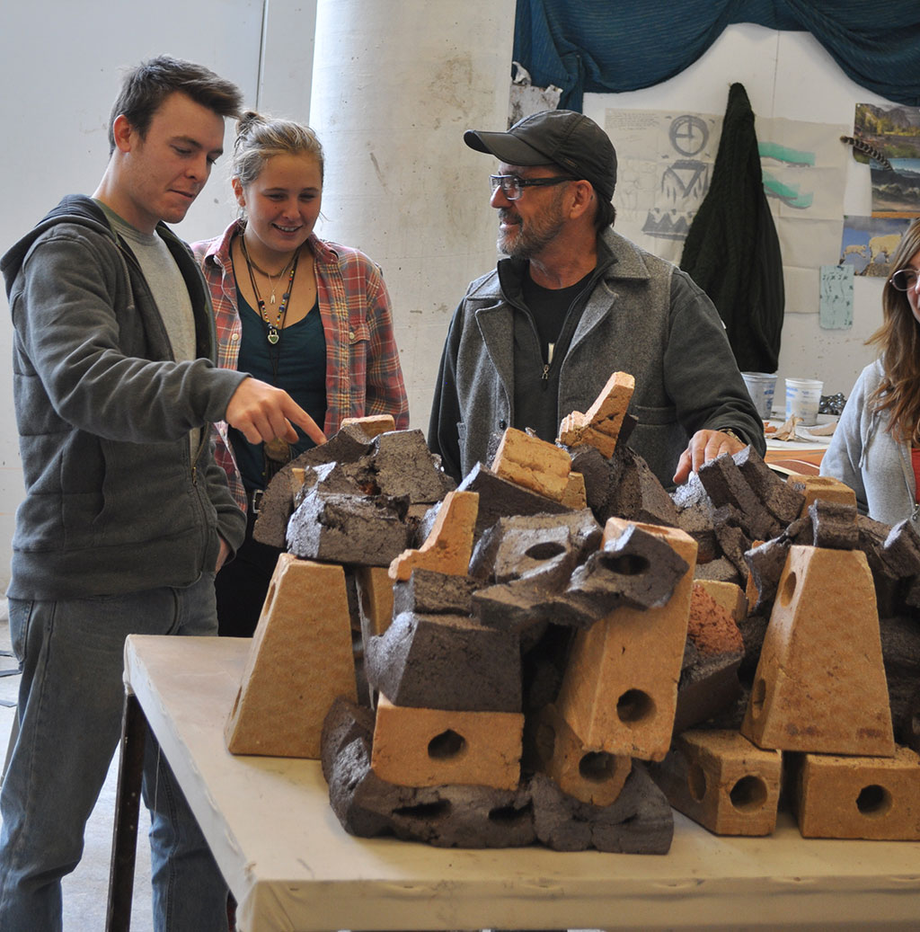 Wayne Higby, Professor of Ceramic Art, works with his students