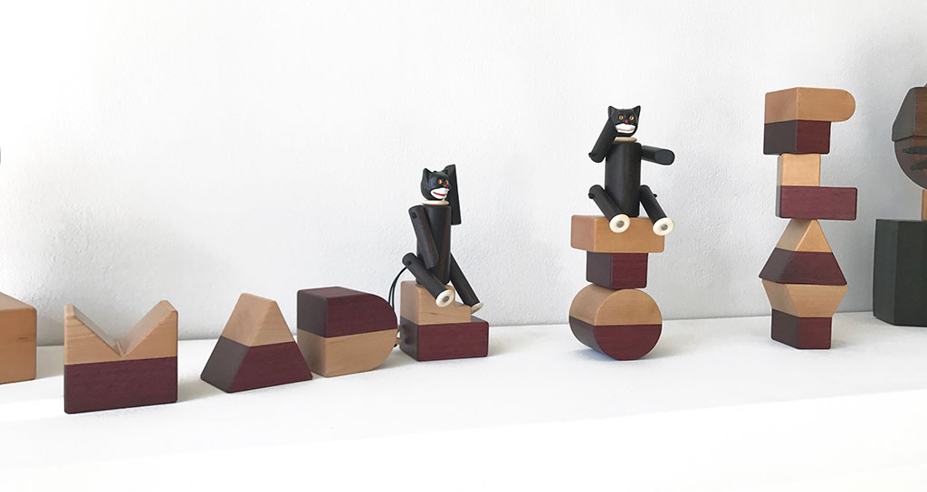 Made to Play, Pamela Weir-Quiton, Cupcake Cats / prototypes, 2018. Ebony with white bone paws and a plastic cupcake topper, elastic, Craft in America