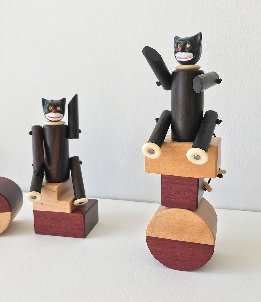 Made to Play, Pamela Weir-Quiton, Cupcake Cats / prototypes, 2018. Ebony with white bone paws and a plastic cupcake topper, elastic, Craft in America