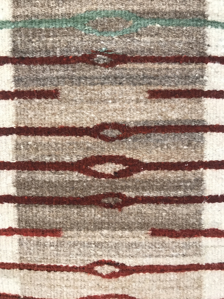 Sandra and Wence Martinez, Ojo de Agua, 2018. Hand spun Churro wool. Un-dyed natural creams, tans and brown. Red is aniline dyed by the artist. Flatweave tapestry. Excellence in Fibers IV, Craft in America
