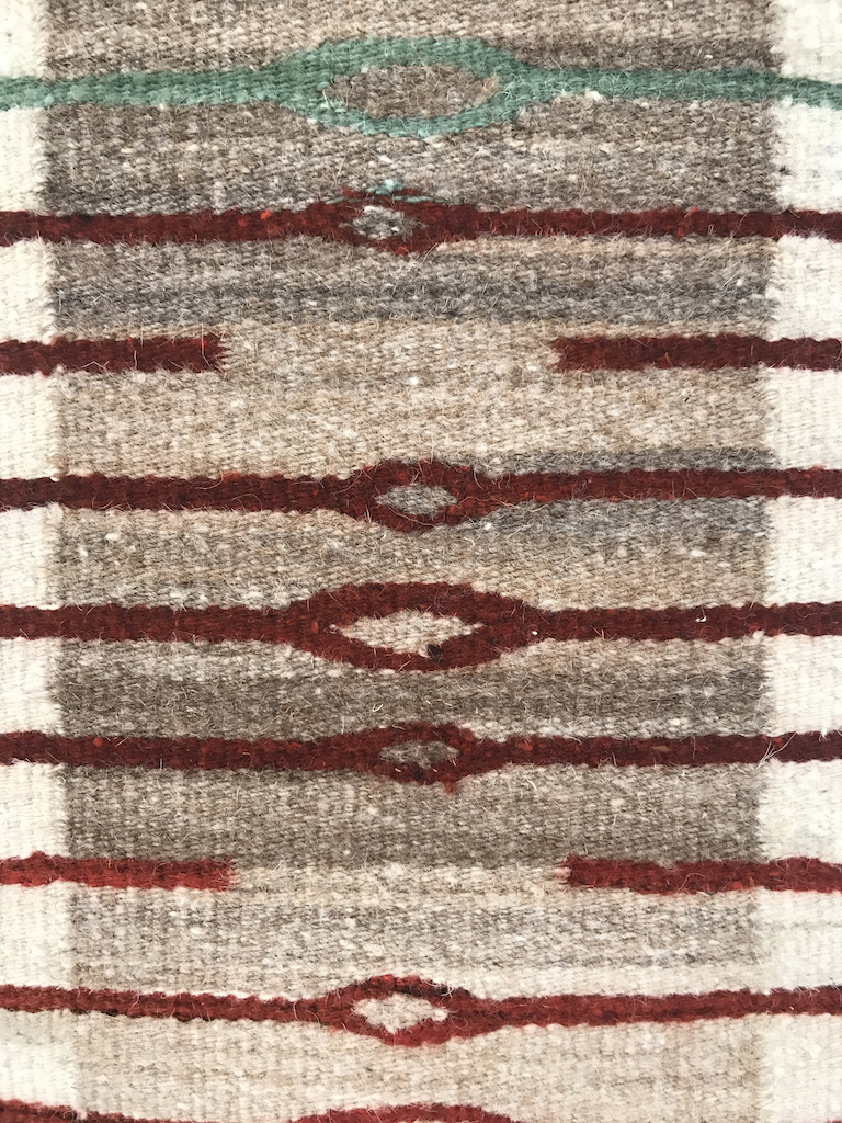 Sandra and Wence Martinez, Ojo de Agua, 2018. Hand spun Churro wool. Un-dyed natural creams, tans and brown. Red is aniline dyed by the artist. Flatweave tapestry. Excellence in Fibers IV, Craft in America 