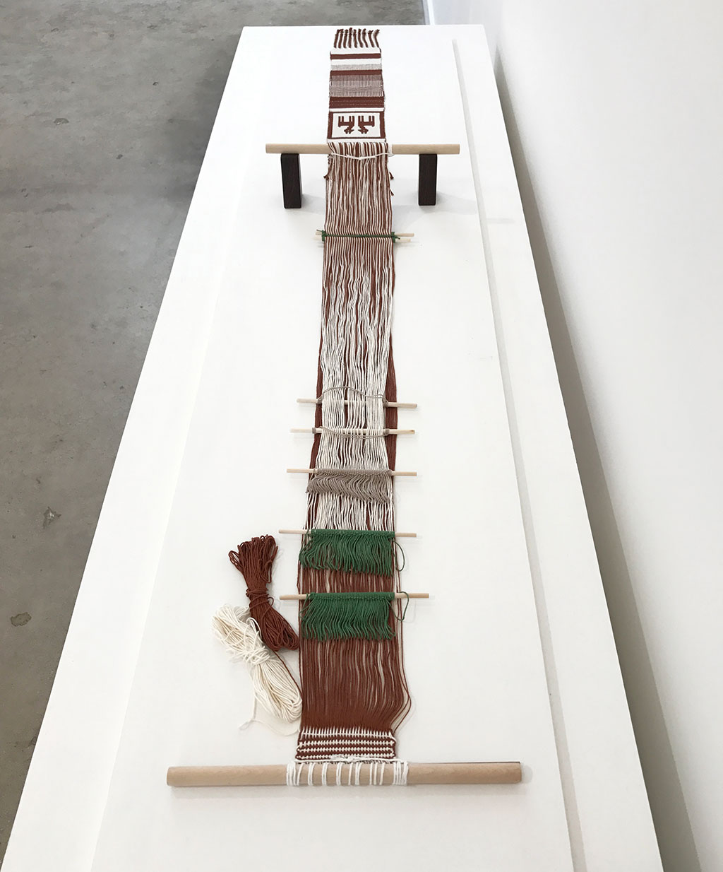 Jennifer Moore, Backstrap loom and double-weave sampler, 2013, cotton, double-weave pickup. Albers dedicated her seminal text, On Weaving, “to my great teachers, the weavers of ancient Peru.” After conquest by the Spanish, some ancient Peruvian weaving techniques, including double-weave, fell into disuse. Nilda Callanaupa, the founder and director of the Center for Traditional Textiles of Cusco, invited Moore to teach double-weave pick-up techniques to members of several Quechua weaving communities at a conference held in Cusco in 2013. This is an example of the looms used and the sampler each weaver made at the conference. Material Meaning: A Living Legacy of Anni Albers, Craft in America