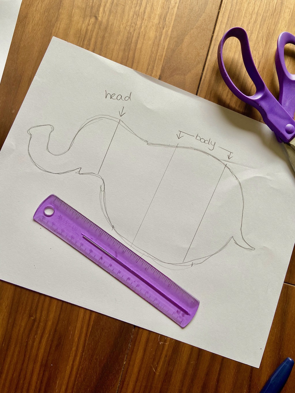 Mark on the top of the base shape where the pieces for the head and body will be (Make at least 2 marks for the body). Draw a line at each mark across the base shape. Use a ruler to measure each line. Write those measurements down to help you remember!