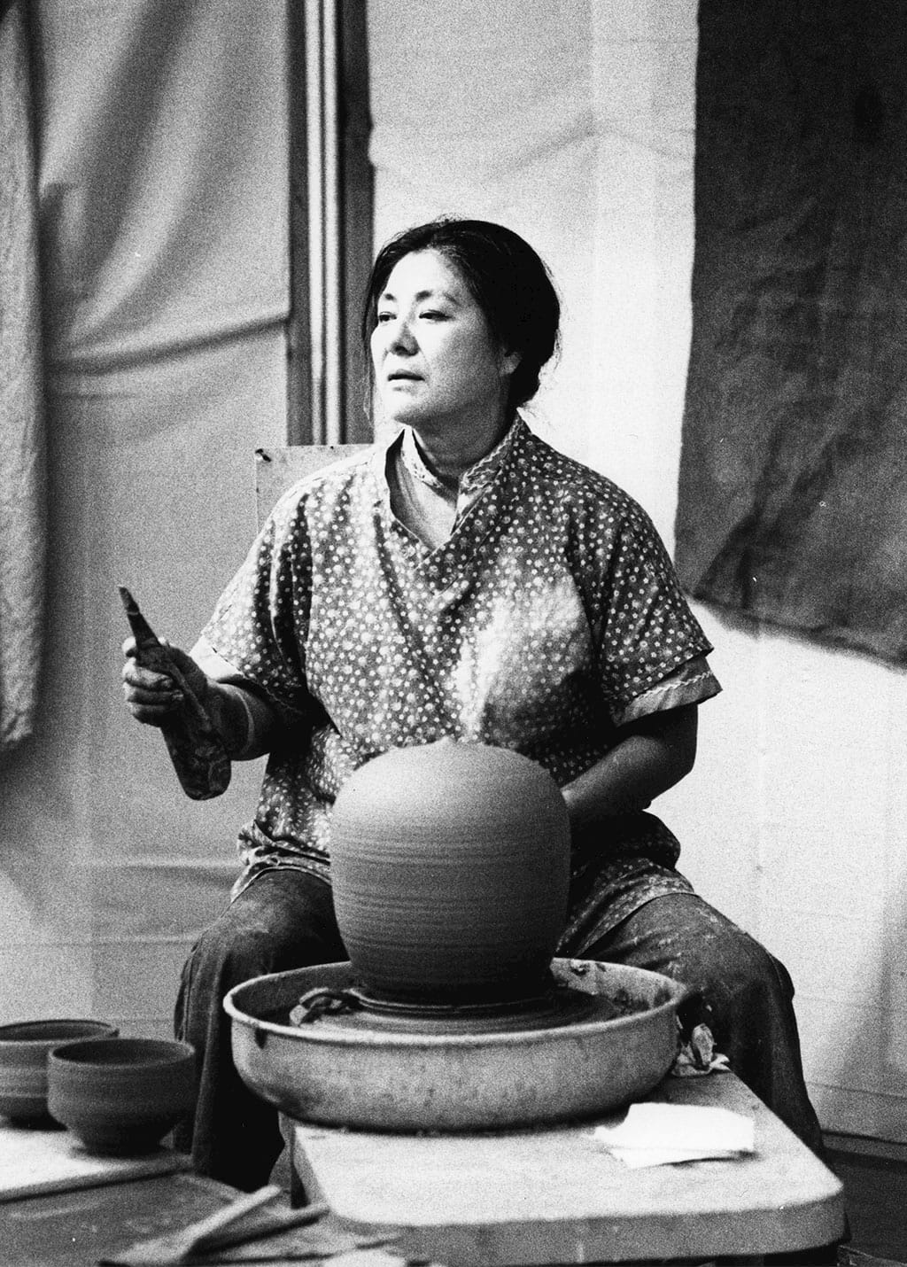 Toshiko Takaezu at the wheel. Courtesy of the American Craft Council