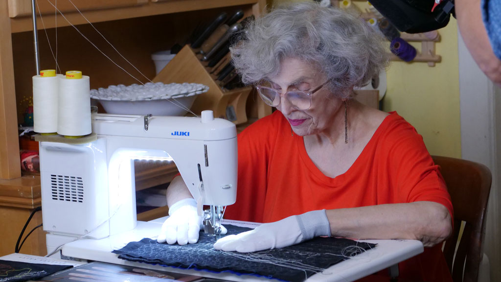 Fiber artist Linda J. Mendelson at the sewing machine. Craft in America STORYTELLERS