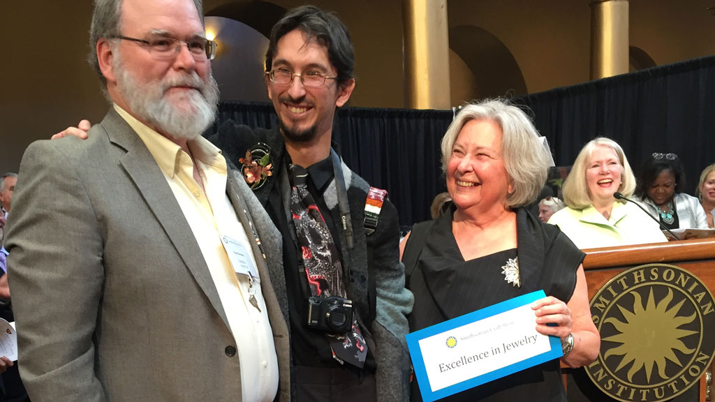 Patrick Benesh-Liu and Carolyn Benesh present an award at the 2016 Smithsonian Craft Show