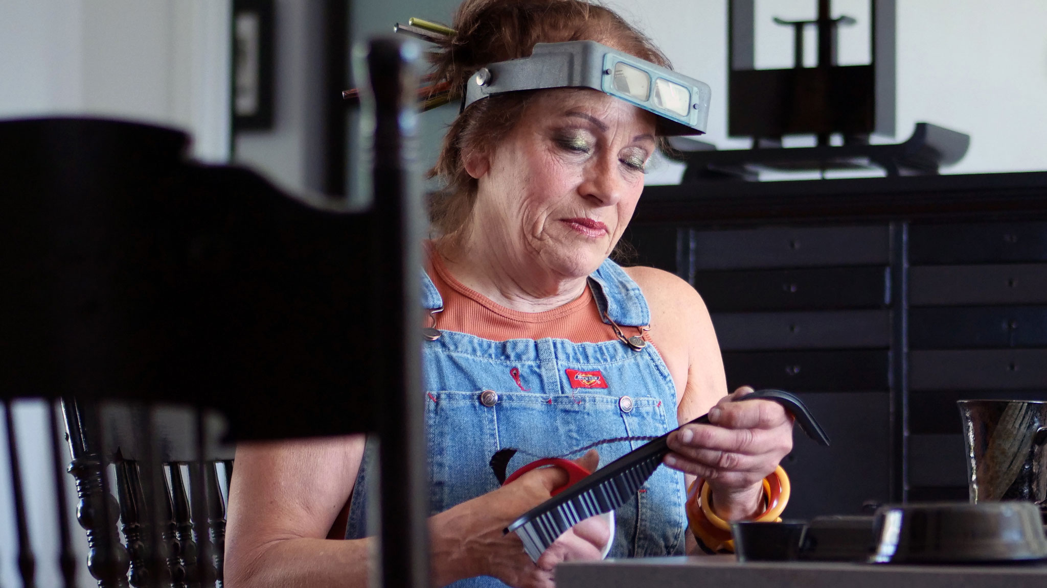 Harriete Estel Berman uses black plastic to create her jewelry. Denise Kang photo. JEWELRY episode of Craft in America