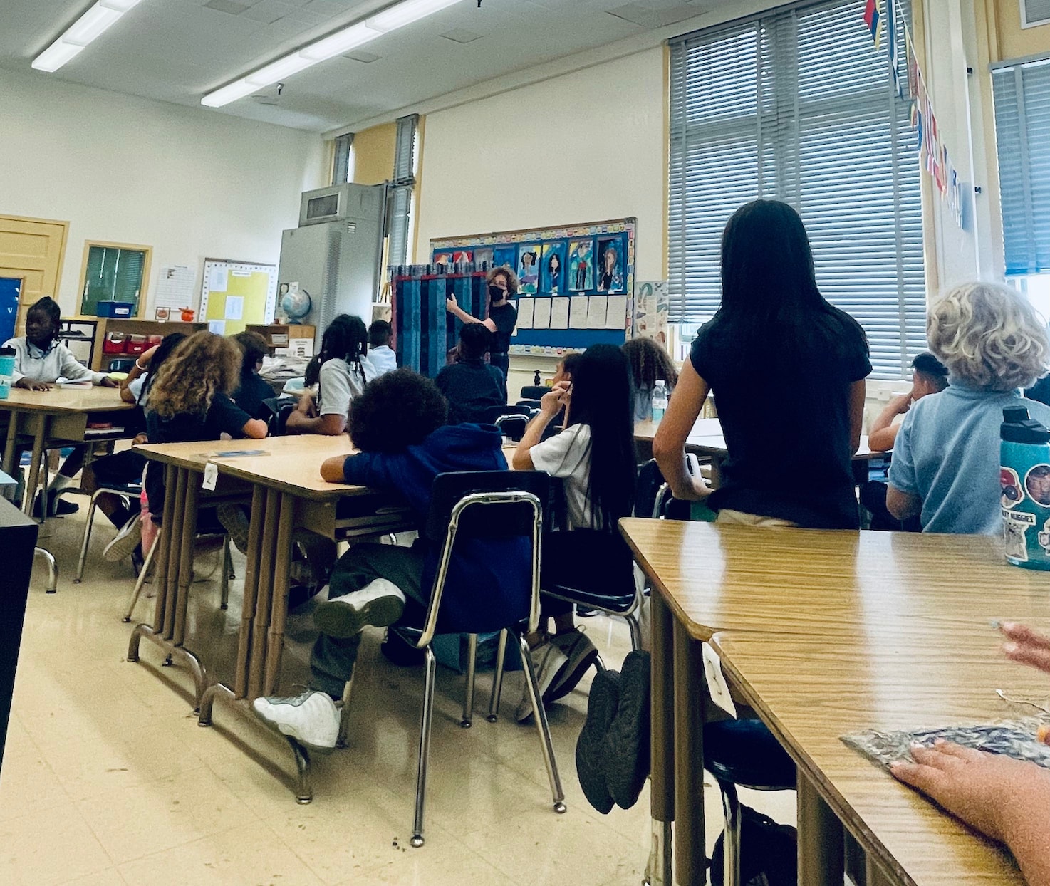 classroom photo of Cameron Taylor Brown showing 4th grade students her woven tapestries