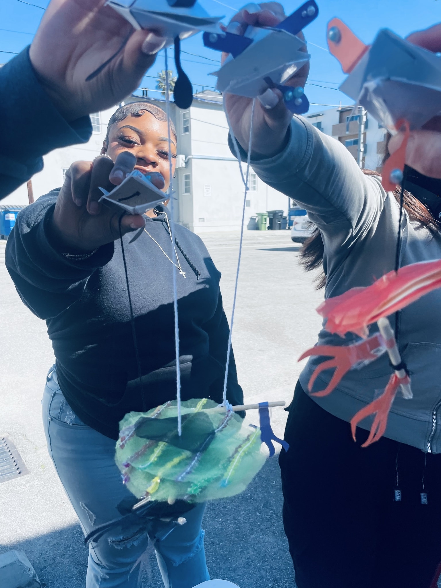 Fairfax High students showing off their origami fabric puppets