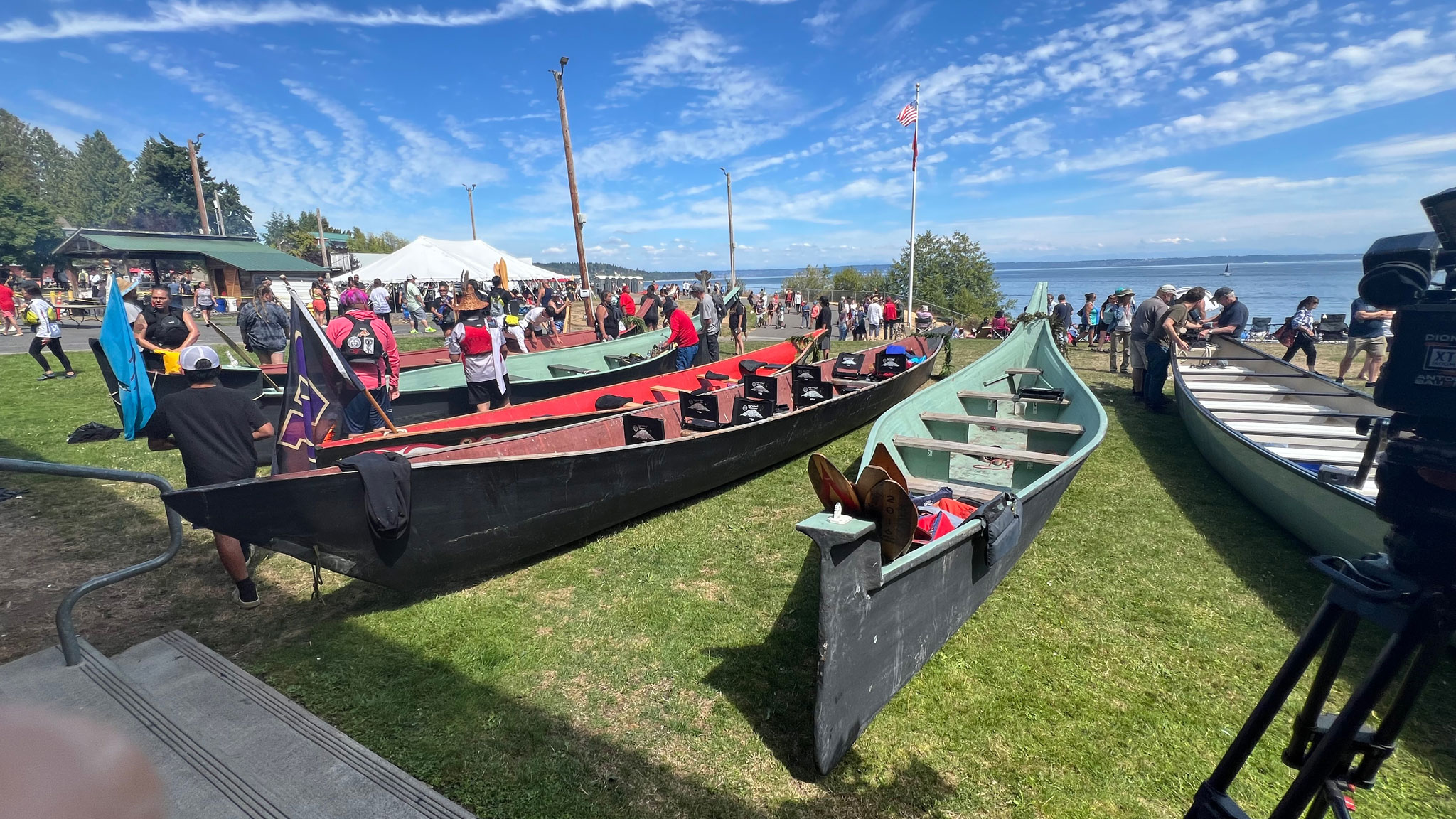 Canoes lined up in a row on a lawn, Denise Kang photograph Craft in America North