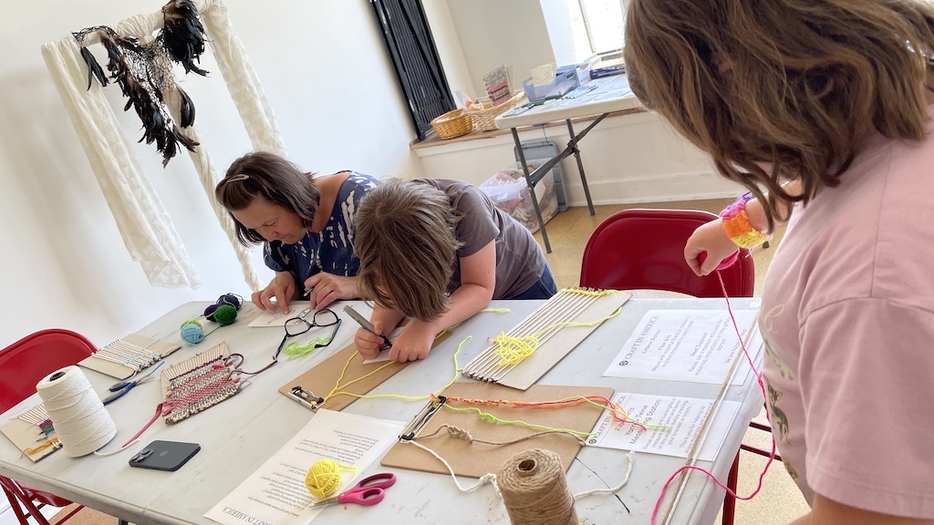 A family creating crafts at Craft in America